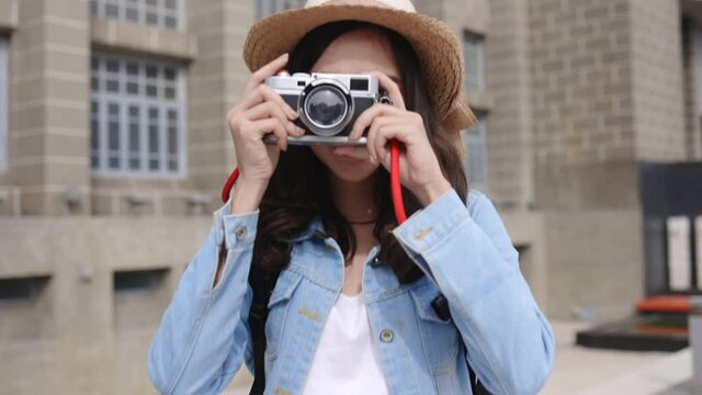 Young Asian women traveler during holidays are happy. Camera to capture travel memories. Freedom to walk in safe city