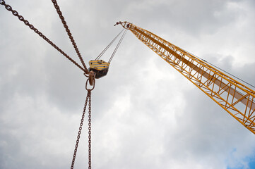 Crane boom with rope, hook and chains.