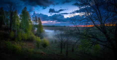 Evening fog, after sunset, rises from the ground and gradually fills the ravine with white clouds of steam