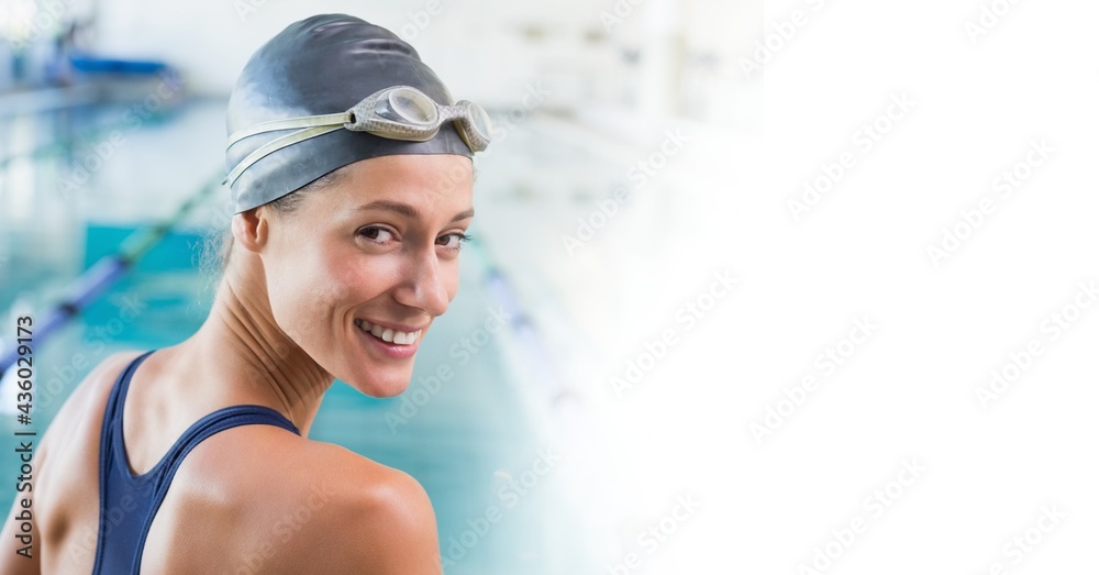 Wall mural composition of portrait of smiling caucasian female swimmer in swimming pool with copy space