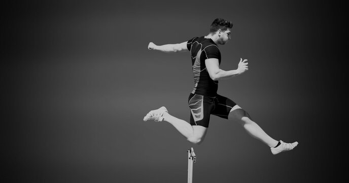 Composition of male hurdle jumper with copy space in black and white