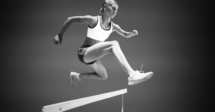 Composition of female hurdle jumper with copy space in black and white