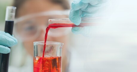 Composition of female scientist holding test tube with red liquid in laboratory and copy space