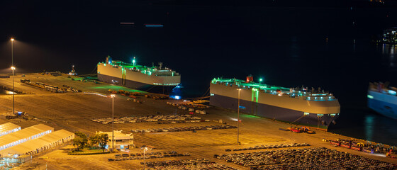 Ro-Ro Ship / car carrier ship anchored at the terminal at night.