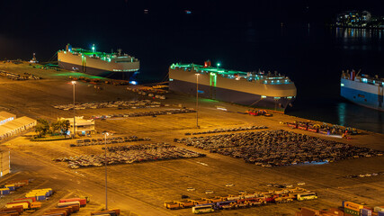 Ro-Ro Ship / car carrier ship anchored at the terminal at night.