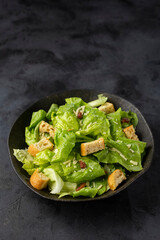 Caesar salad with croutons and bacon.
