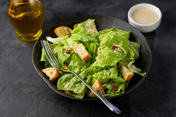 Caesar salad with croutons and bacon.