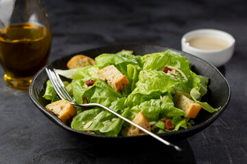 Caesar salad with croutons and bacon.