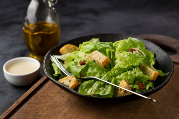 Caesar salad with croutons and bacon.