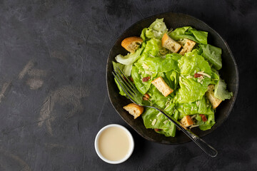 Caesar salad with croutons and bacon.