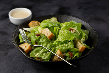 Caesar salad with croutons and bacon.