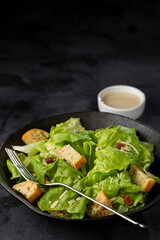Caesar salad with croutons and bacon.