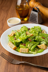 Caesar salad with croutons and bacon.