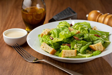 Caesar salad with croutons and bacon.