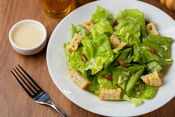 Caesar salad with croutons and bacon.