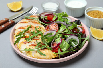 Concept of tasty eating with salad with grilled chicken on gray background