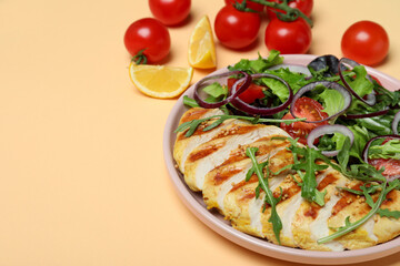 Salad with grilled chicken and ingredients on beige background