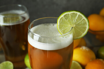 Glass of beer with lime slice, close up