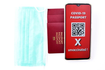 Traveling during SARS-CoV-19 pandemic. Traditional passport and Covid-19 passport application in mobile phone.