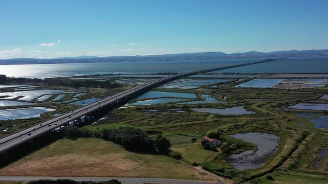 Aerial View Of Traffic At Vasco da Gama Bridge Over Tagus River In Parque das Nacoes, Lisbon, Portugal.