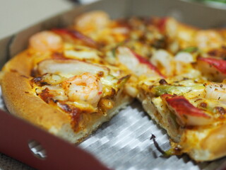 Pizza Seafood Cocktail pan on top with Shrimp, Crab Sticks, Ham, Pineapple and Sauce in paper box, fast food