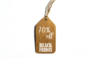 Online shopping, Promotion Black Friday Sale 70% text on brown tag on white background.