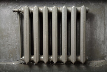 Working cast-iron retro radiator on a gray background. 