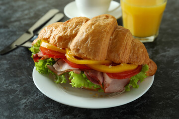Concept of tasty eating with croissant sandwich, close up