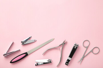 Tools of a manicure set on pink background with copy space.