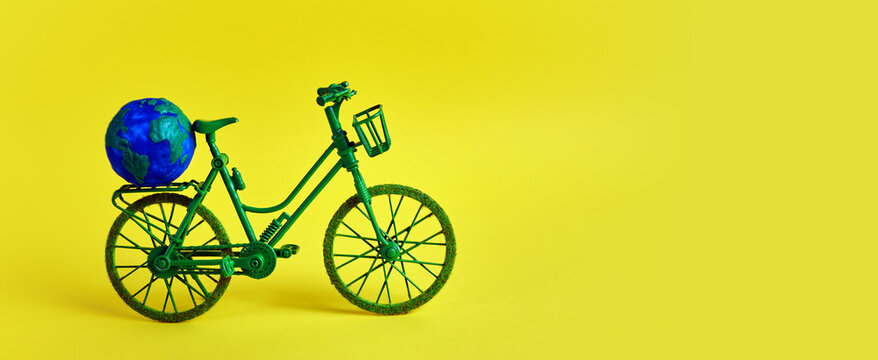 3rd June World Bicycle Day. Green bicycle on yellow background. Environment preserve.