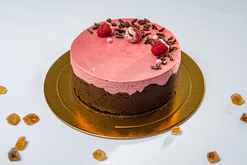 Round chocolate and strawberry cake with berries and chocolate flakes