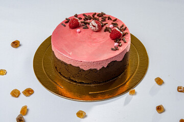 Round chocolate and strawberry cake with berries and chocolate flakes