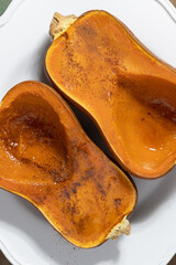 Roasted winter squash dessert, close-up, garnished with cinnamon and honey, cropped, top view