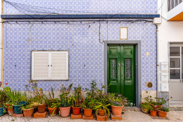 Fototapeta na wymiar A house with traditional Portuguese tiles in Olhao, Algarve, Portugal
