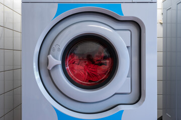 Laundry. Washer. Washing linen. The centrifuge spins and washes laundry and clothes. The laundry is open. Linen in bright colors