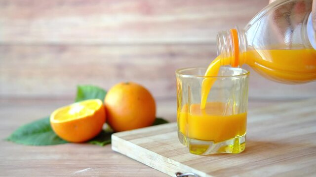 fresh orange and glass of juice on table 