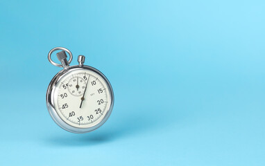 Stopwatch in levitation on blue background. Template Copy space for text