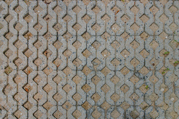 Sand and old concrete block pavement pattern texture background. Pattern of brick worm floor, View...