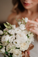 Obraz na płótnie Canvas focus on flowers. bride with a bouquet. Wedding traditions.
