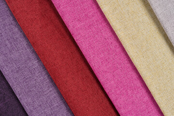 Multi-colored samples of woven textiles. Catalog and palette tone of Interior fabric for furniture, closeup.