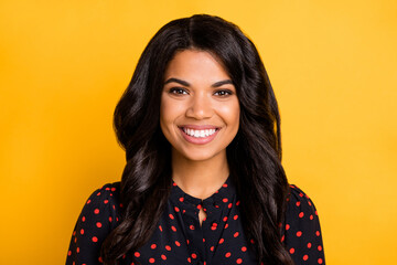 Photo of gorgeous friendly dark skin lady toothy smile look camera isolated on bright yellow color...