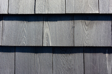 Close view of newer grayed cedar shingles in rows