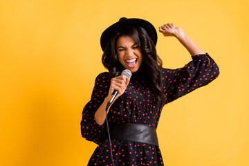 Photo of pretty crazy dark skin girl open mouth singing loud closed eyes isolated on yellow color background