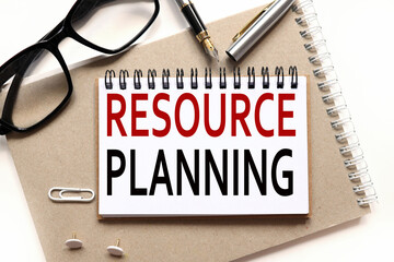 resource planning. text on paper, on a notebook on a craft background, near glasses