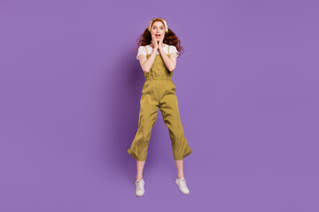 Full length body size view of attractive cheerful stunned girl jumping wow news isolated over violet purple color background
