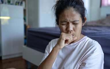 Fototapeta na wymiar Young asian woman has a cough and sore throat.