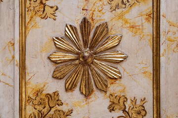 Daisy flower carved in gold color over wood