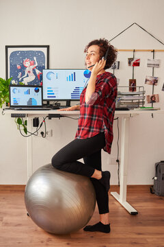 Woman telecommuting at an adjustable standing desk