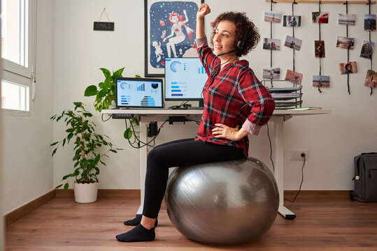 Woman teleworking sitting on a fitball