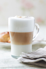 Glass of Latte Macchiato. Bright background. Close up.